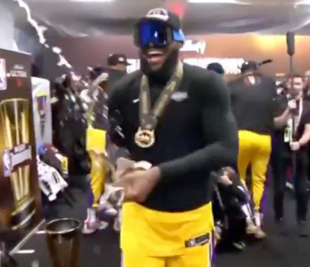 LeBron James sprays champagne in the Lakers' locker room following the team's In-Season Tournament win on Dec. 9, 2023.