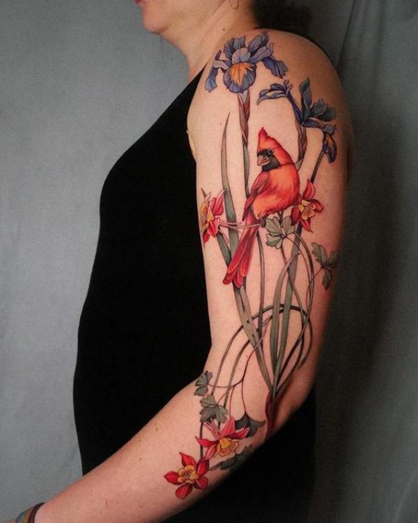 Iris and daffodil with cardinal back of arm tattoo