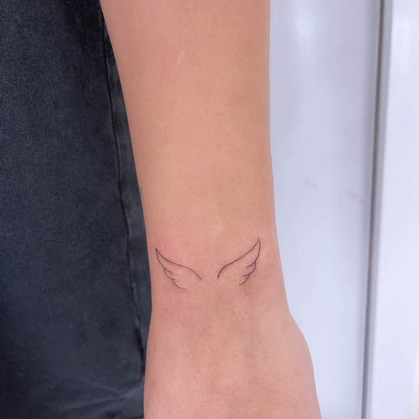 Simple small angel wrist tattoo by @teagantatt
