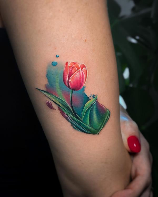 Watercolor tulip back of arm tattoo