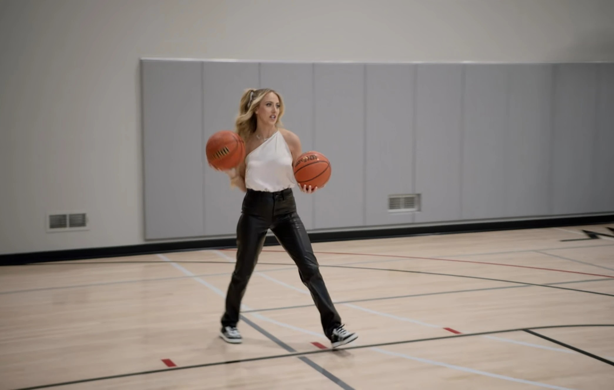 Brittany plays basketball on the indoor court