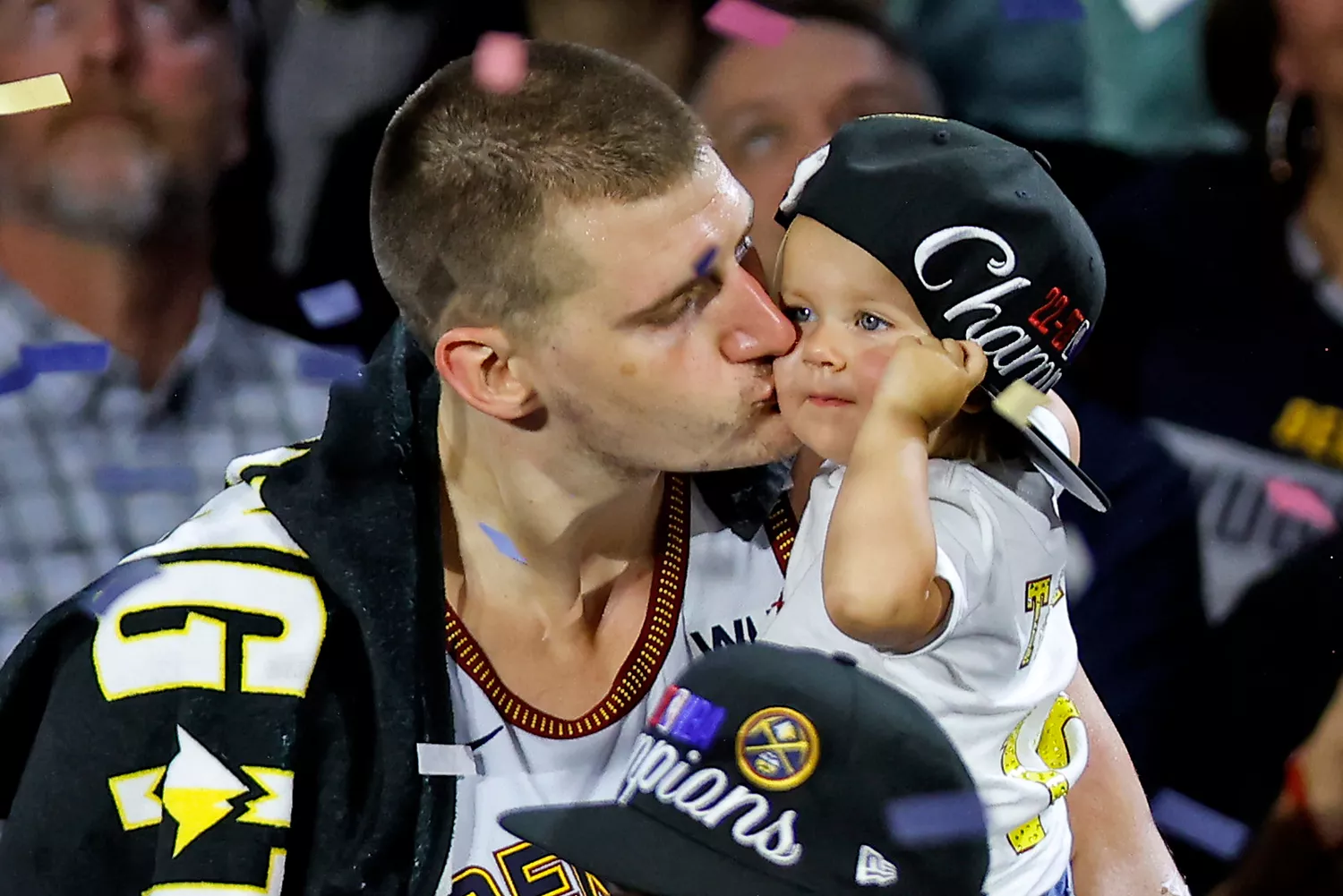 Nikola Jokic #15 of the Denver Nuggets celebrates with his daughter Ognjena after a 94-89 victory against the Miami Heat in Game Five of the 2023 NBA Finals to win the NBA Championship at Ball Arena on June 12, 2023 in Denver, Colorado.