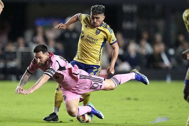 Inter Miami forward Lionel Messi, front, falls to the field after coming into contact with Real Salt Lake midfielder Pablo Ruiz during the first half of an MLS soccer match Wednesday, Feb. 21, 2024, in Fort Lauderdale, Fla. Ruiz was given a yellow card on the play. (AP Photo/Lynne Sladky)