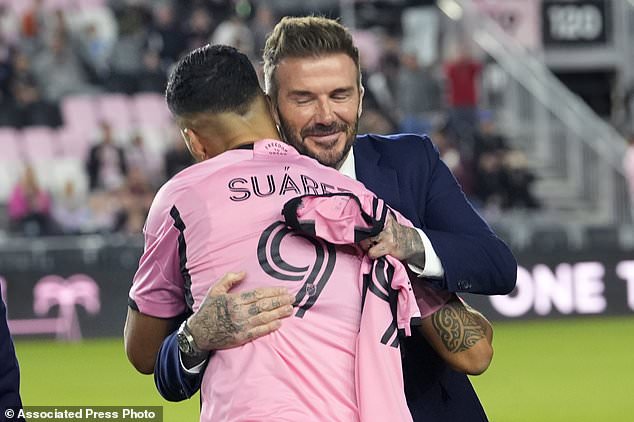 Inter Miami co-owner David Beckham, right, hugs forward Luis Suarez (9) before the team's MLS soccer match against Real Salt Lake, Wednesday, Feb. 21, 2024, in Fort Lauderdale, Fla. (AP Photo/Lynne Sladky)