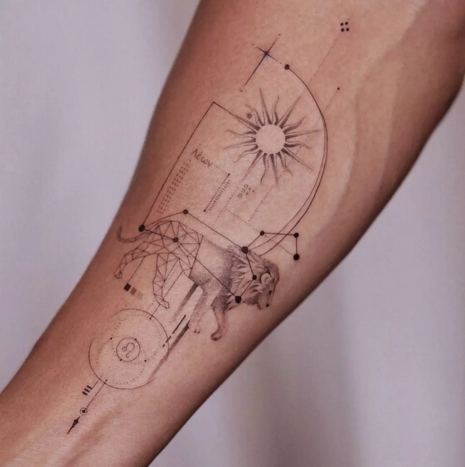 A geometric leo zodiac arm tattoo