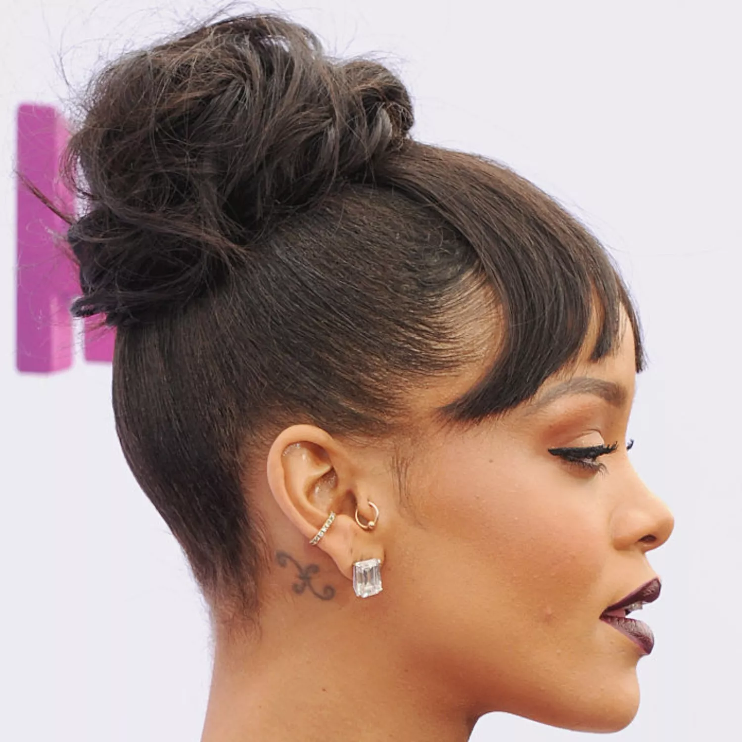zoomed-in photo of Rihanna with Pisces astrological sign tattoo behind the ear