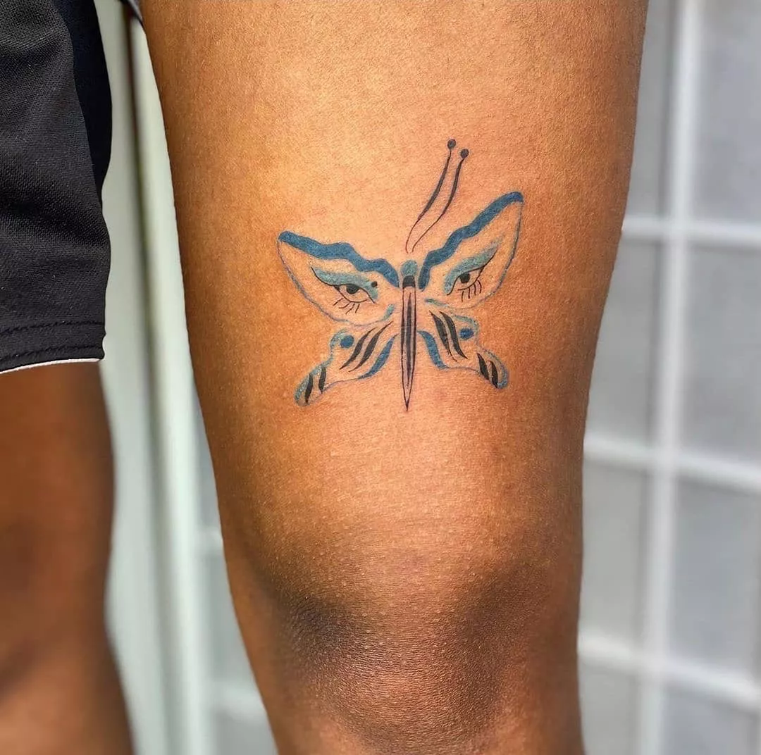 Close up of tattoo above the knee with eye design