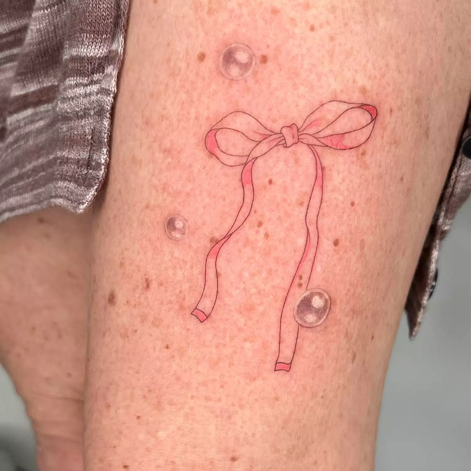 Bow tattoo with bubbles