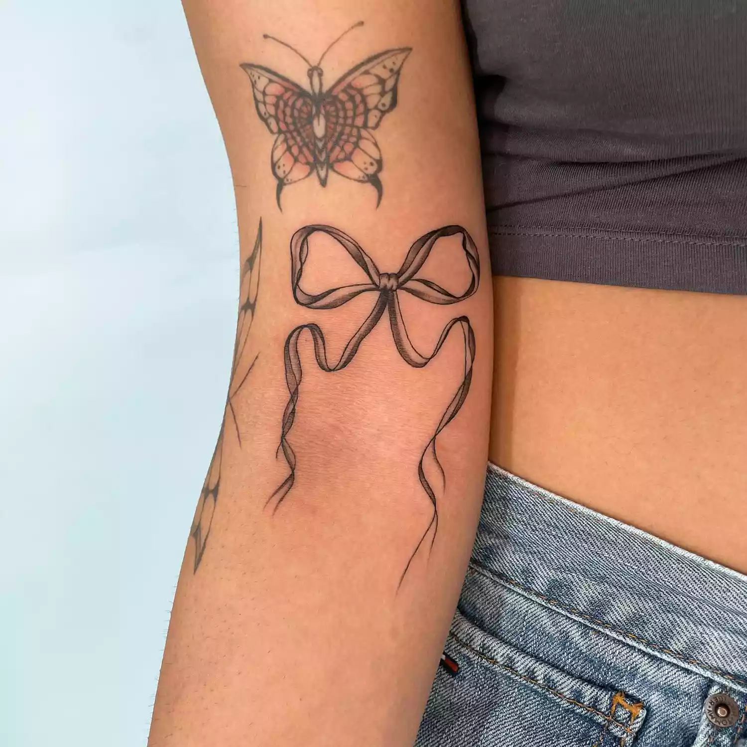 woman with a bow and butterfly tattoo
