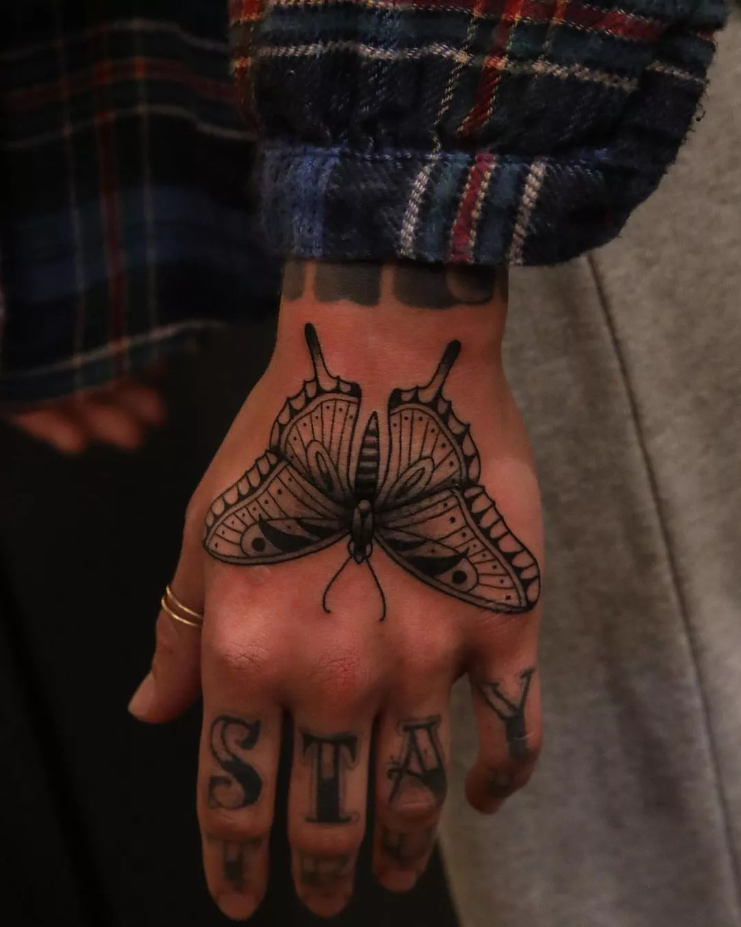 Close up of butterfly tattoo on the back of the hand