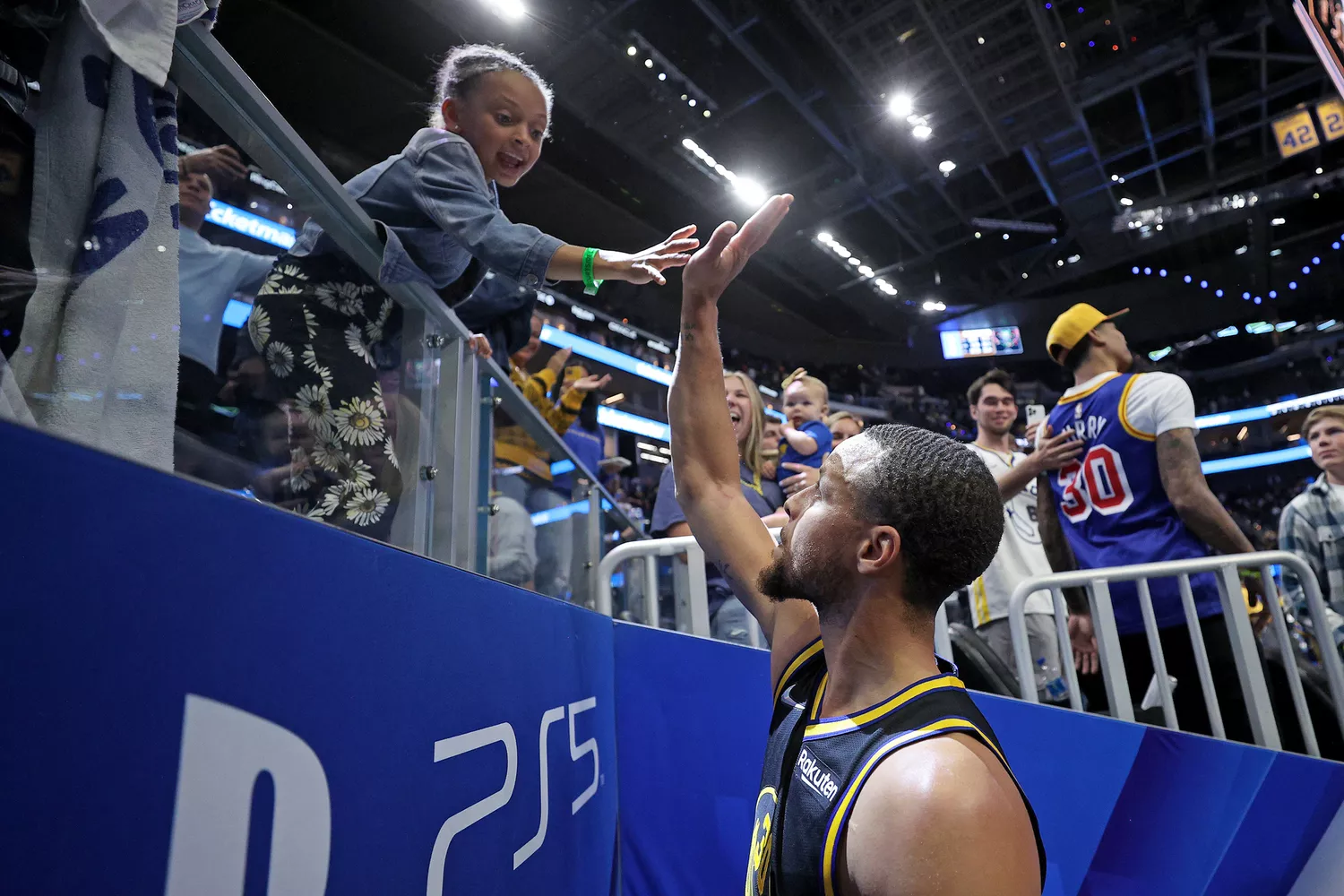 Stephen Curry #30 of the Golden State Warriors talks with his daughter, Ryan, after the Warriors beat the Denver Nuggets in Game Five of the Western Conference First Round NBA Playoffs at Chase Center on April 27, 2022 in San Francisco, California.