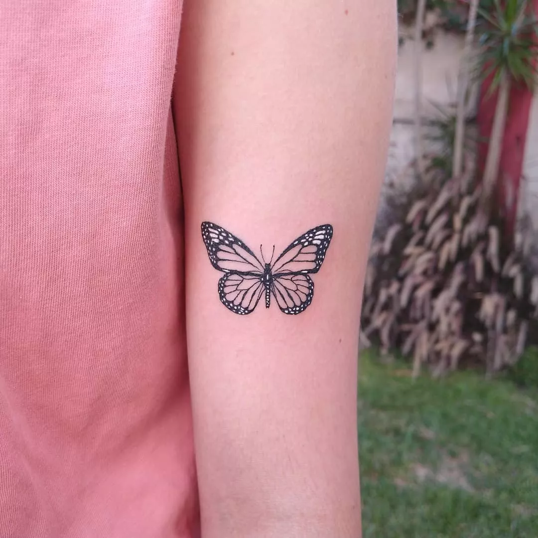 Close up of butterfly tattoo on back of arm