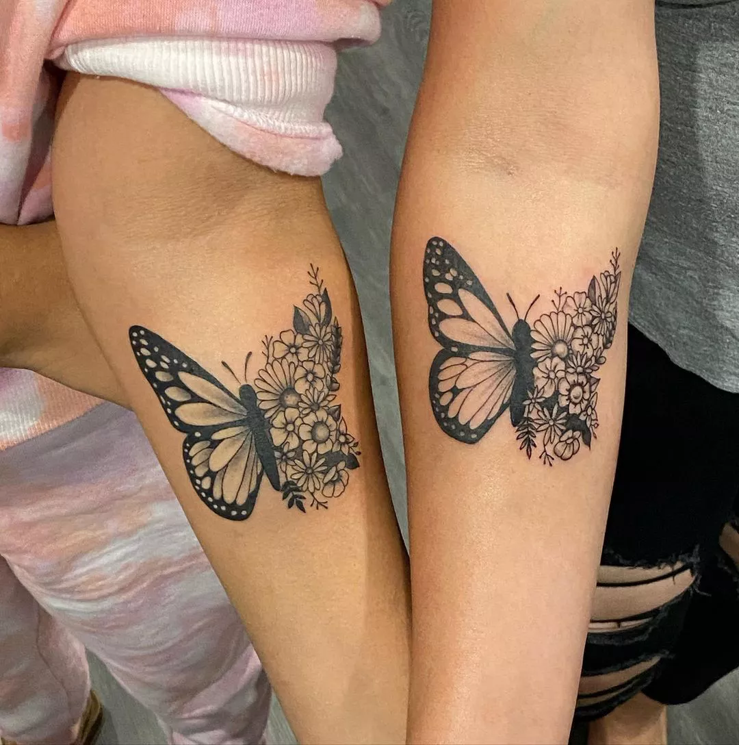 Matching butterfly tattoos on two arms