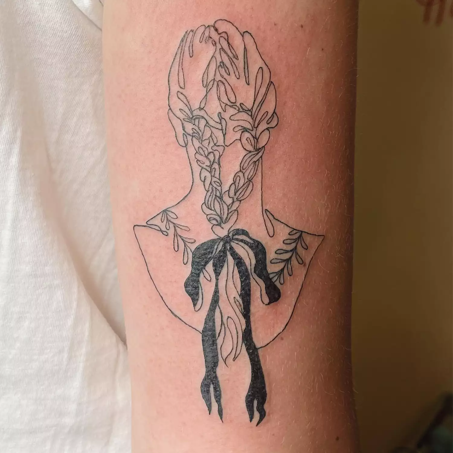 Tattoo of a bust with a bow