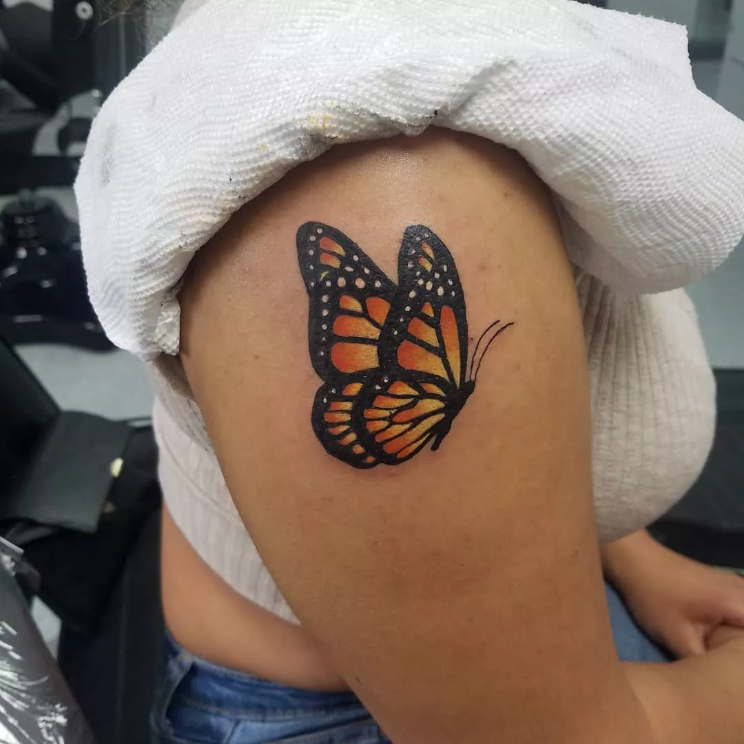 Close up of orange and black butterfly tattoo