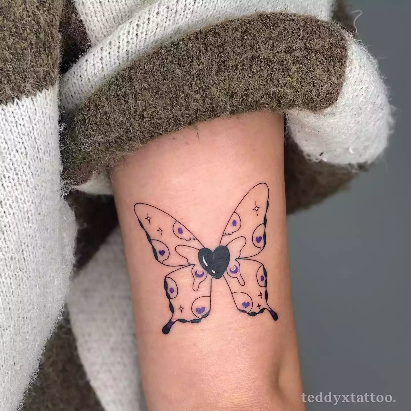 Butterfly wing tattoo with Kuromi design