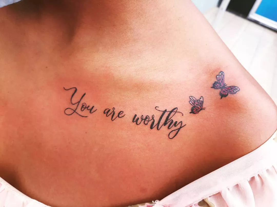 Words tattoo on the collarbone with butterflies