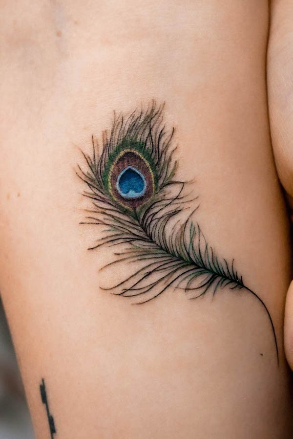 Detailed peacock feather tattoo by @natashapanattoni