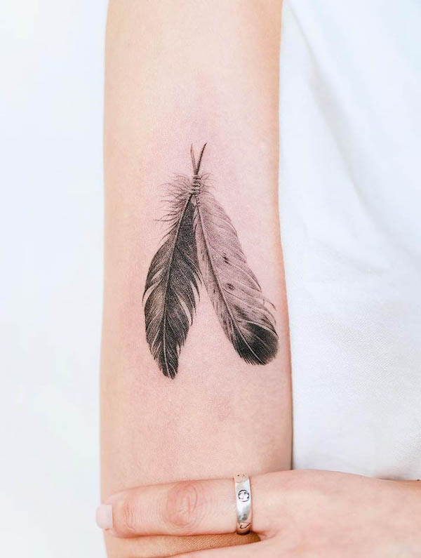 Realism yin and yang feather tattoo by @nandotattooer