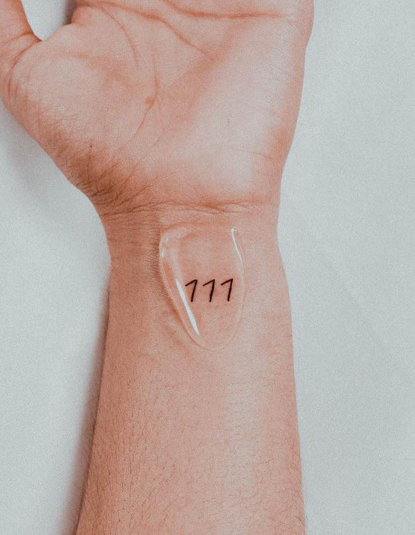 777 Angel number wrist tattoo by @m.a.i_ink