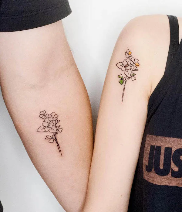 Matching bouquet tattoos for father and daughter by @heim__tattoo