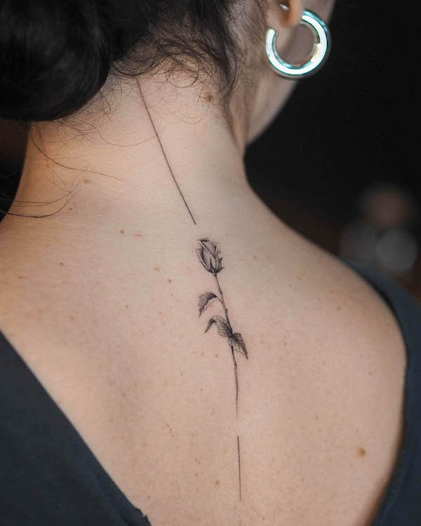 Fine line rose spine tattoo by @ayhanmetin