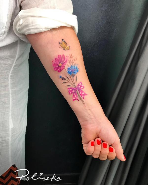 A bouquet of cornflower and cosmos flower tattoo