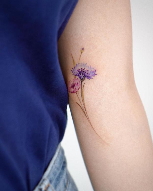 Pink and purple cornflower bicep tattoo
