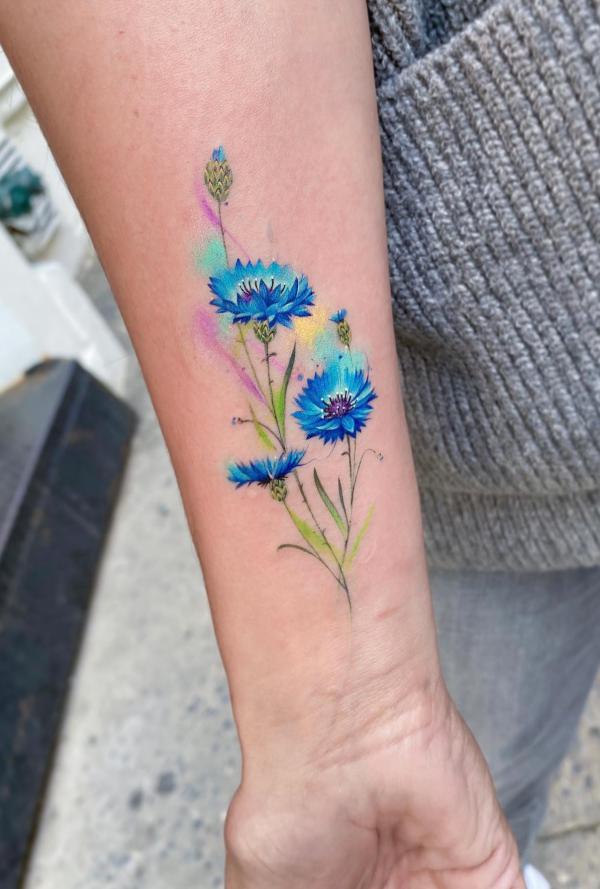 Watercolor cornflower inner forearm tattoo