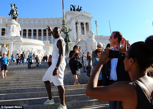 Snap happy: He posed again in front of his new wife Savannah Brinson as they looked around the Altare della Patria