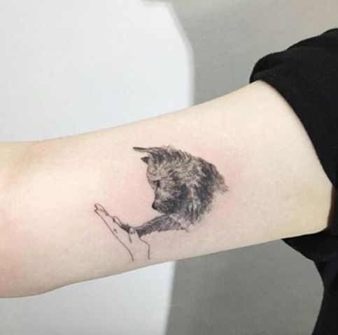 Cute dog tattoo on the arm