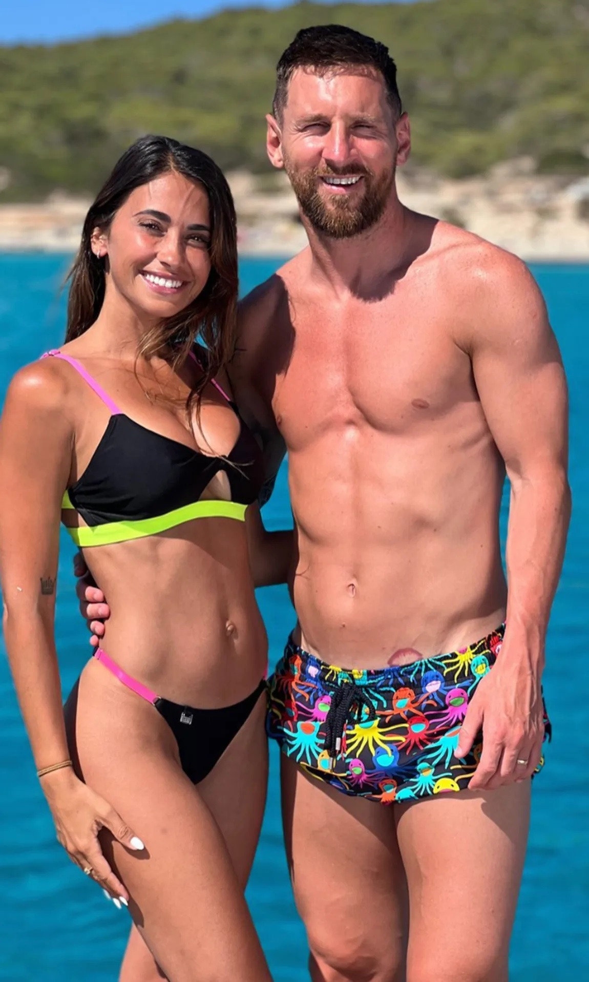 Lionel Messi shows off his muscular physique in flashy shorts as he cuddles up to wife Antonela Roccuzzo on a luxury yacht during Ibiza holiday with Luis Suarez