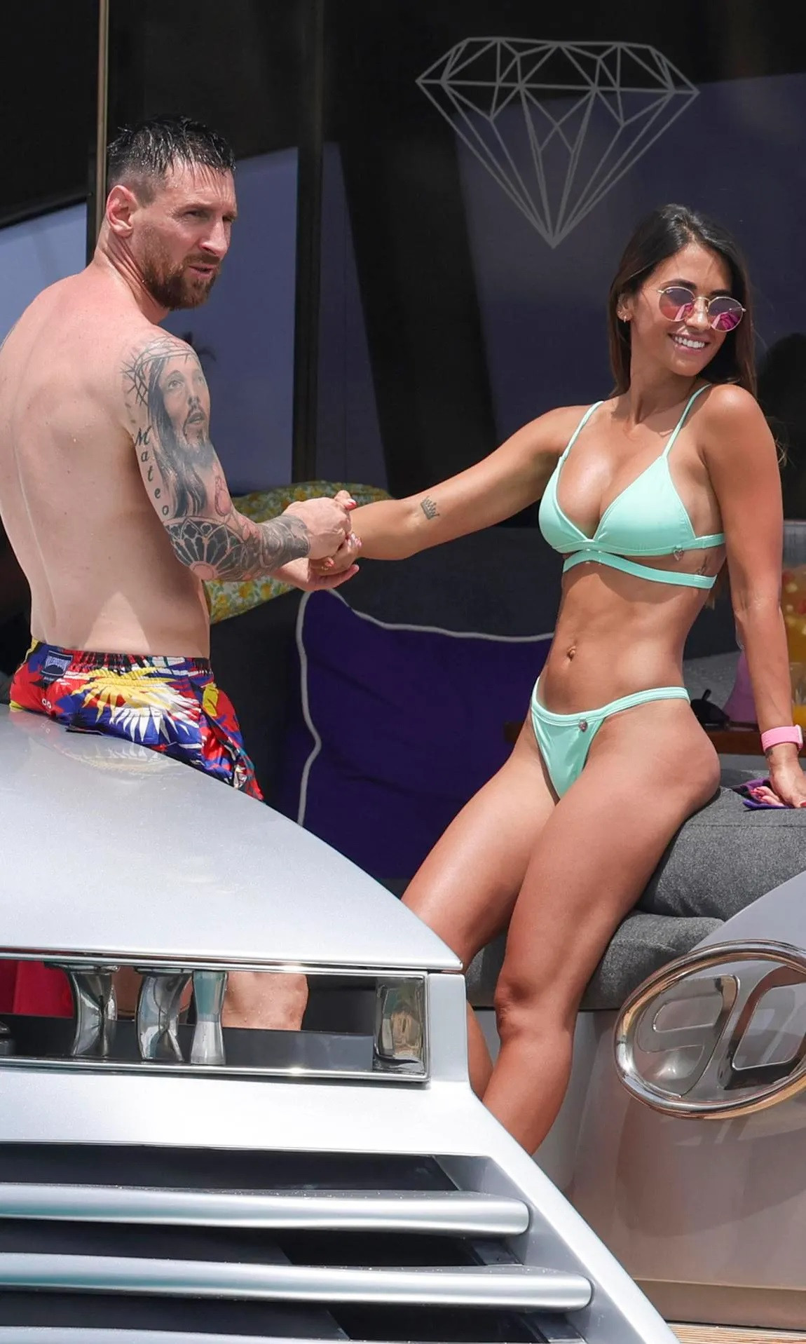 Lionel Messi shows off his muscular physique in flashy shorts as he cuddles up to wife Antonela Roccuzzo on a luxury yacht during Ibiza holiday with Luis Suarez