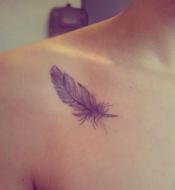 A faded feather clavicle tattoo