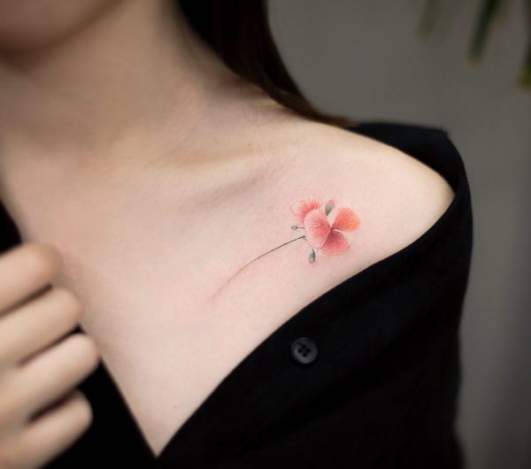 Minimalist iris clavicle tattoo