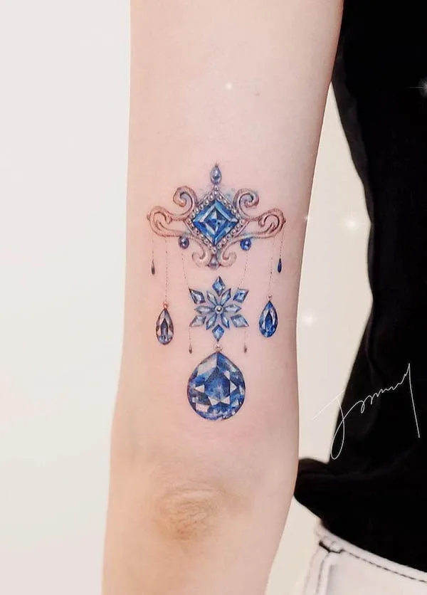 Gemstone jewelry above elbow tattoo by @tattooist_jammy.j