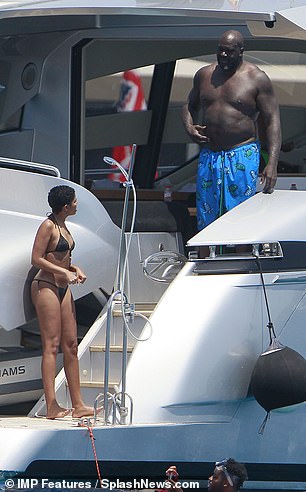 Chatting: The couple looked in great spirits as they chatted on the yacht