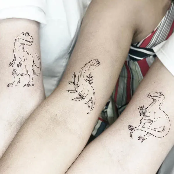 Matching dinosaur tattoos for best friends by @misart.tattoo