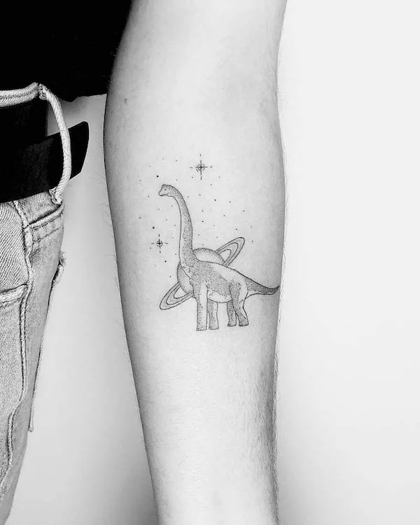 Small diplodocus and galaxy forearm tattoo by @lotty_ink