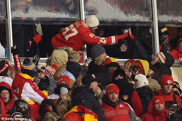 Taylor Swift gave Chiefs fan Beth Vancil (pictured high-fiving the singer) her scarf at the game