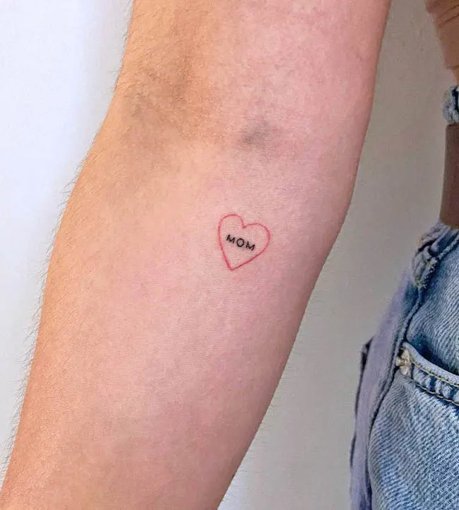 Small heart tattoo in dedication to mom by @mikelovetattooer