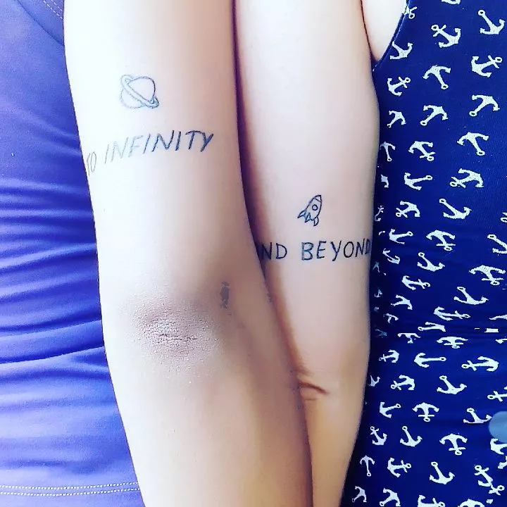 Close up of the back of two arms with to infinity and beyond tattoos