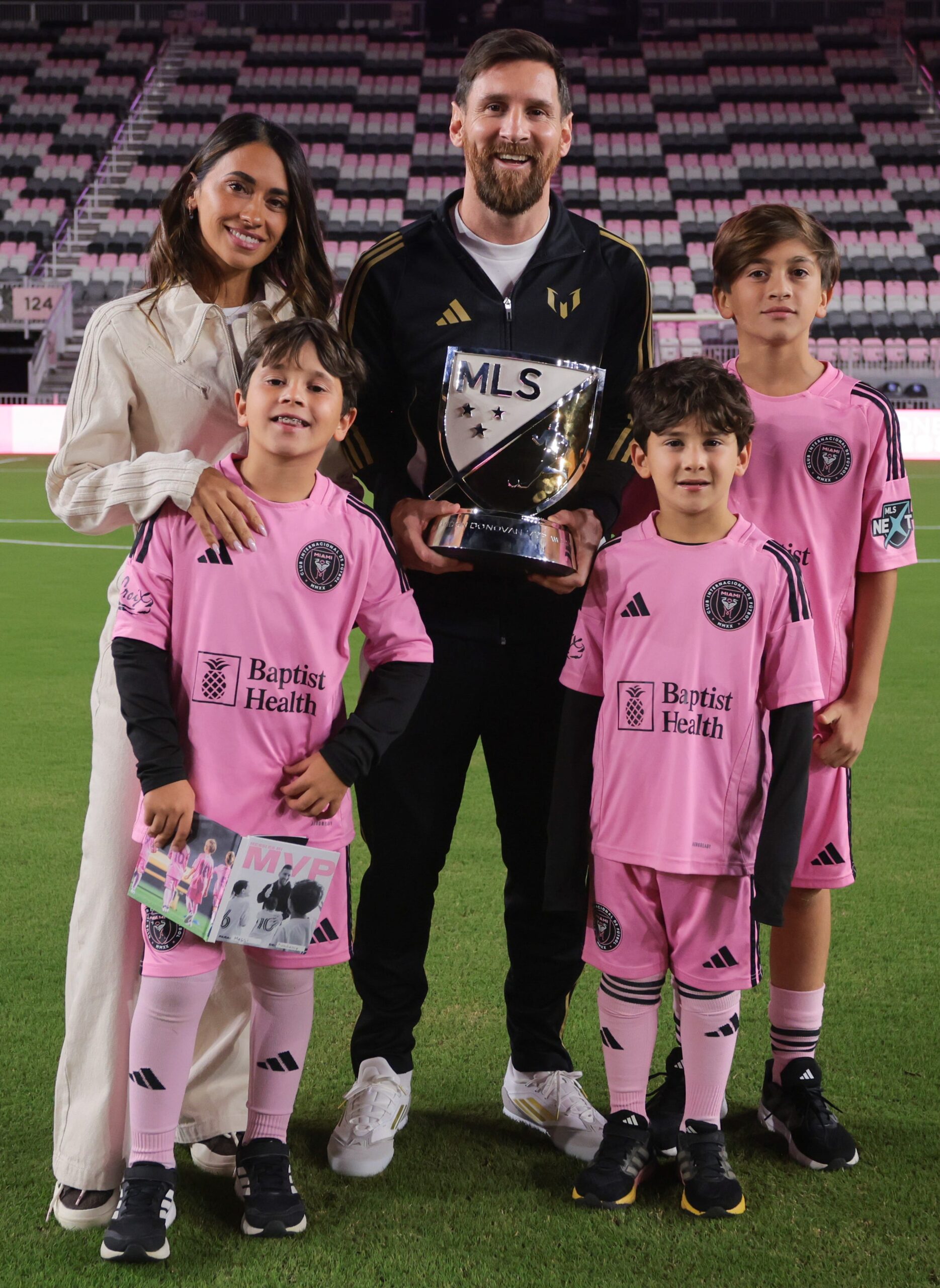 Inter Miami CF forward Lionel Messi (10) is photographed with his wife Antonela Roccuzzo and their sons Mateo, Ciro, and Thiago holding the Landon Donovan MVP Award during a presentation ceremony at Chase Stadium in Fort Lauderdale, Fla., on Dec. 4, 2024.