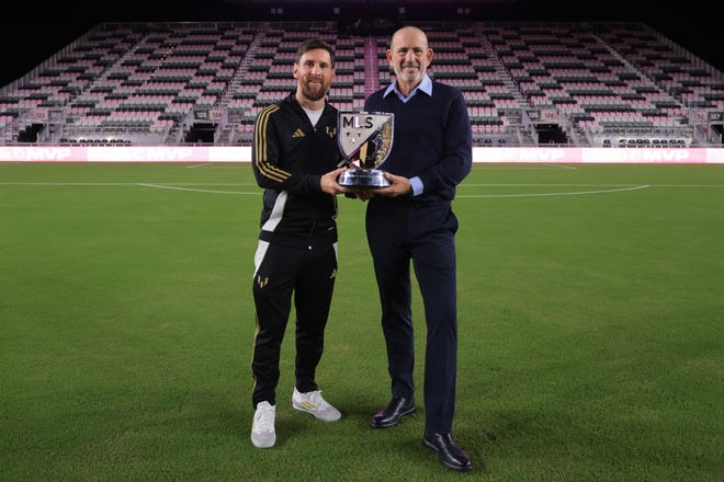 Inter Miami CF forward Lionel Messi (10) and MLS commissioner Don Garber hold the London Donovan MVP Award during a presentation ceremony at Chase Stadium on Dec 4, 2024 in Ft. Lauderdale, Florida, USA.