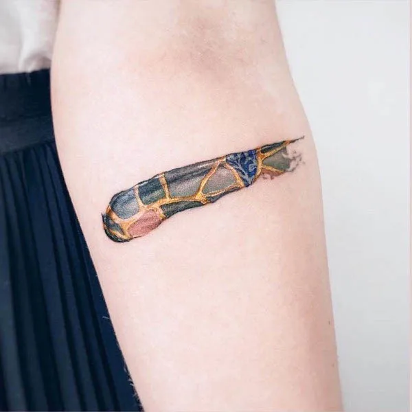 Kintsugi brushstroke tattoo by @marina_giorgia