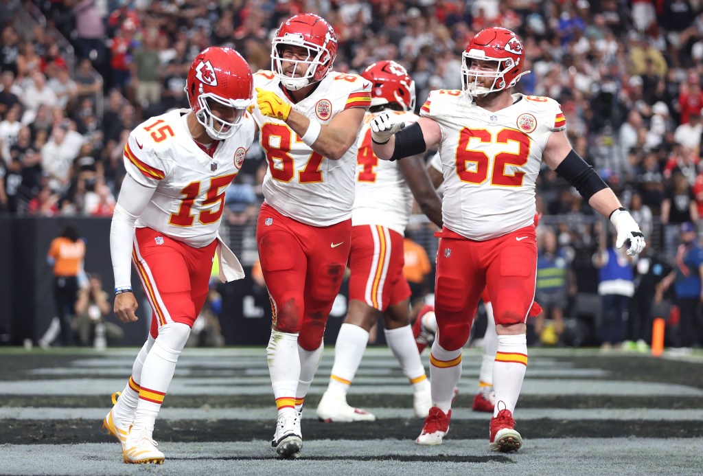 Patrick Mahomes #15, Travis Kelce #87, and Joe Thuney #62 of the Kansas City Chiefs celebrate after Kelce's receiving touchdown in the second quarter of a game against the Las Vegas Raiders at Allegiant Stadium on October 27, 2024 in Las Vegas, Nevada.