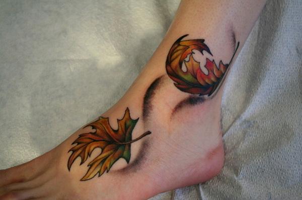 Dark fallen leaves foot tattoo