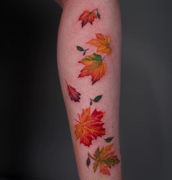 Falling Autumn leaves leg tattoo