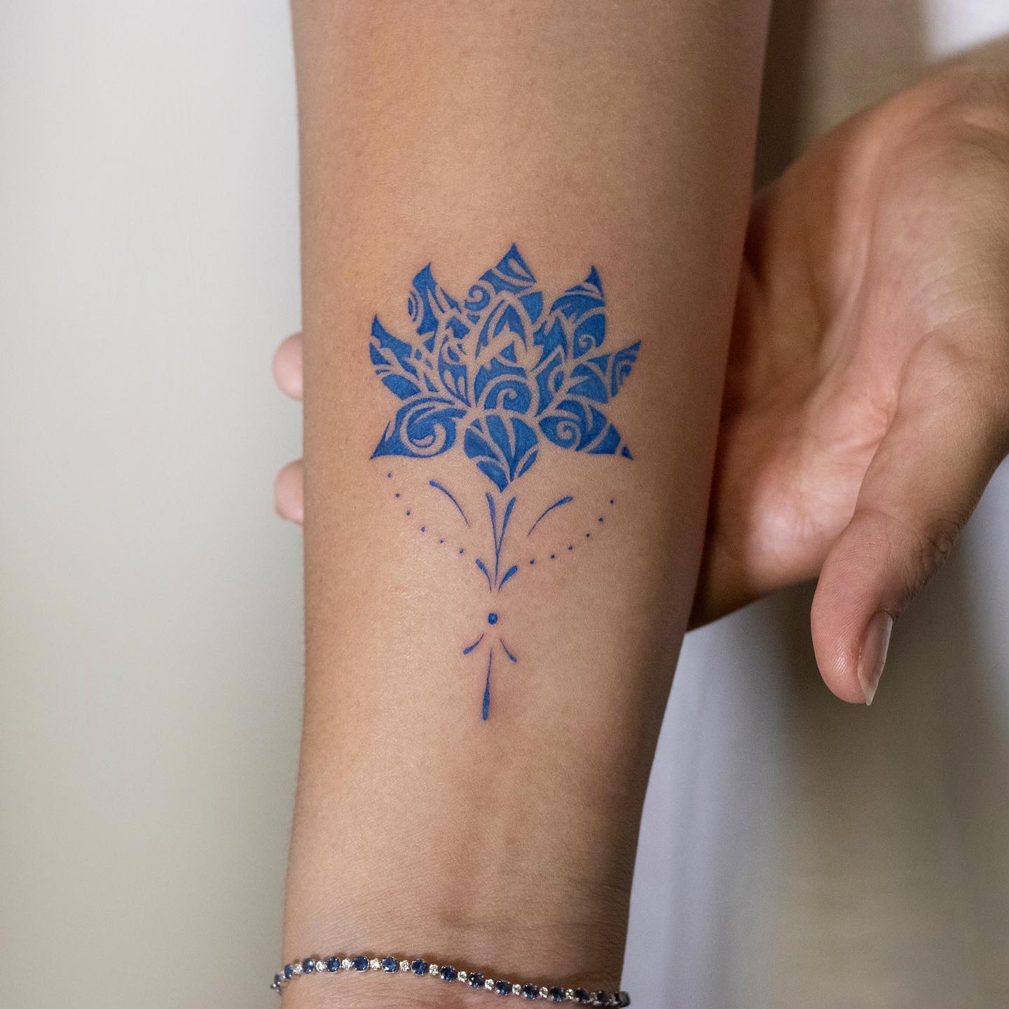 Porcelain lotus flower tattoo on the forearm