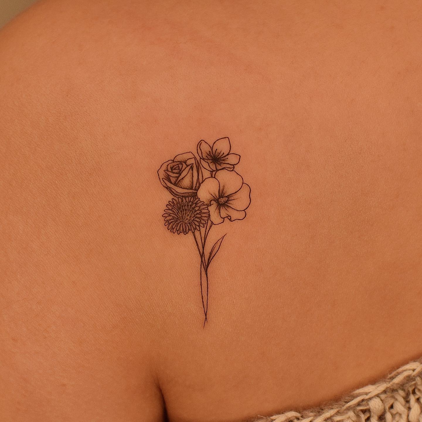 Adorable flowers tattooed on the front shoulder